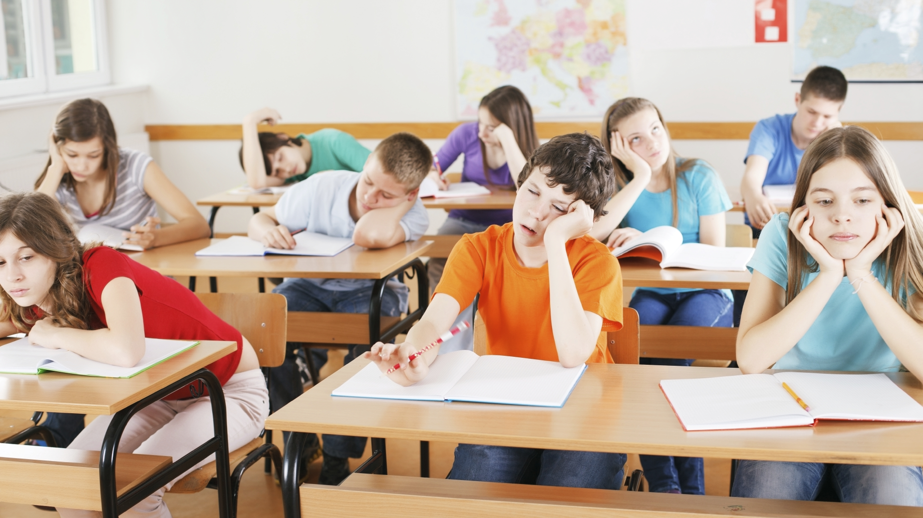 Schoolchildren bored in a classroom, during lesson.