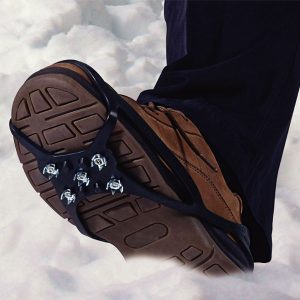 image shows snow grippers attached to bottom of boots