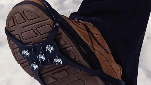 image shows snow grippers attached to bottom of boots