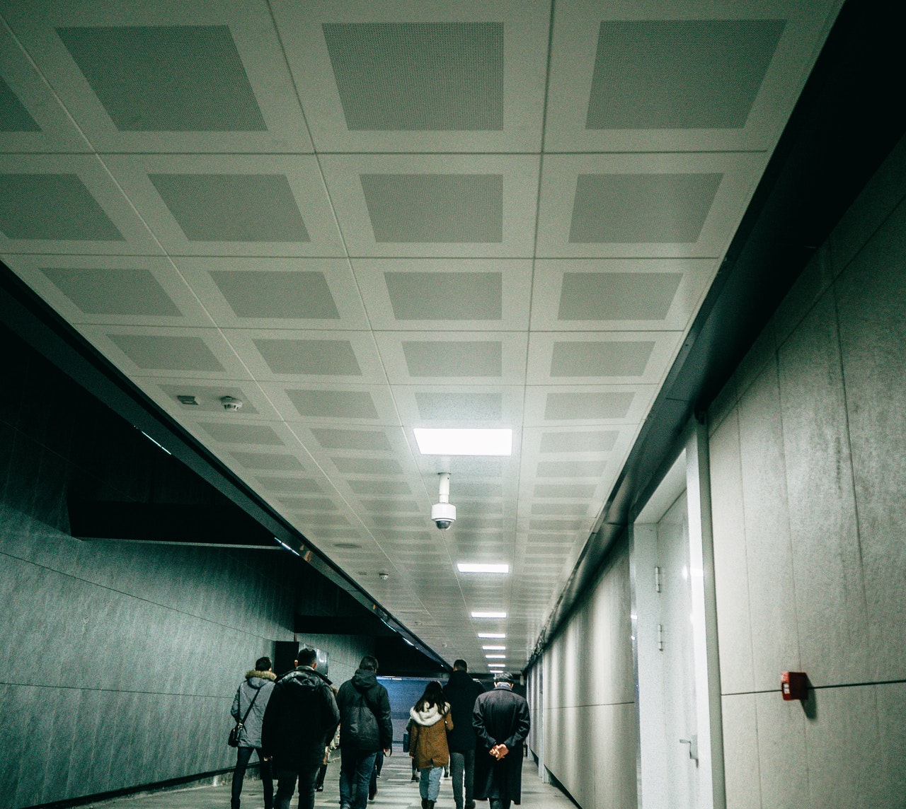 Image shows long hall to subway station exit.