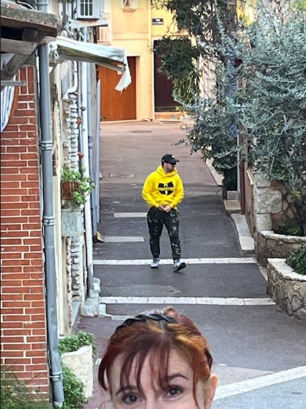 Image shows a stranger walking down the street in a WuTang shirt.