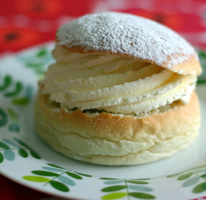 image shows a delicious semla, which is a Swedish dessert for Fat Tuesday.