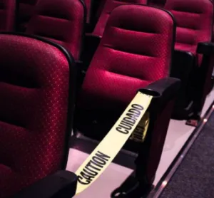 image shows movie theater seats with caution tape