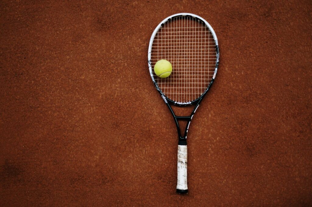 image shows a tennis racket and ball
