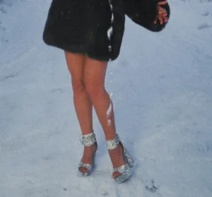 image shows woman wearing high heel shoes in the snow on valentine's day in Sweden