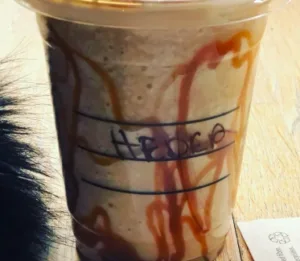 image shows a starbucks cup that says Heder